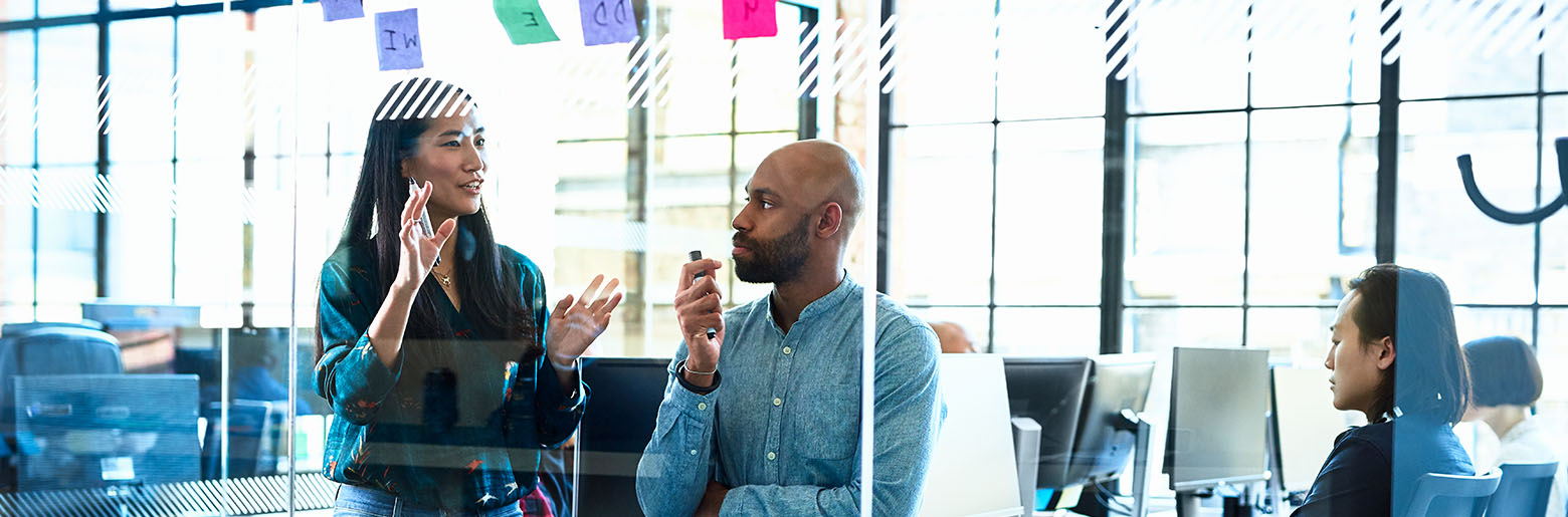 Male and female colleague discussing a project