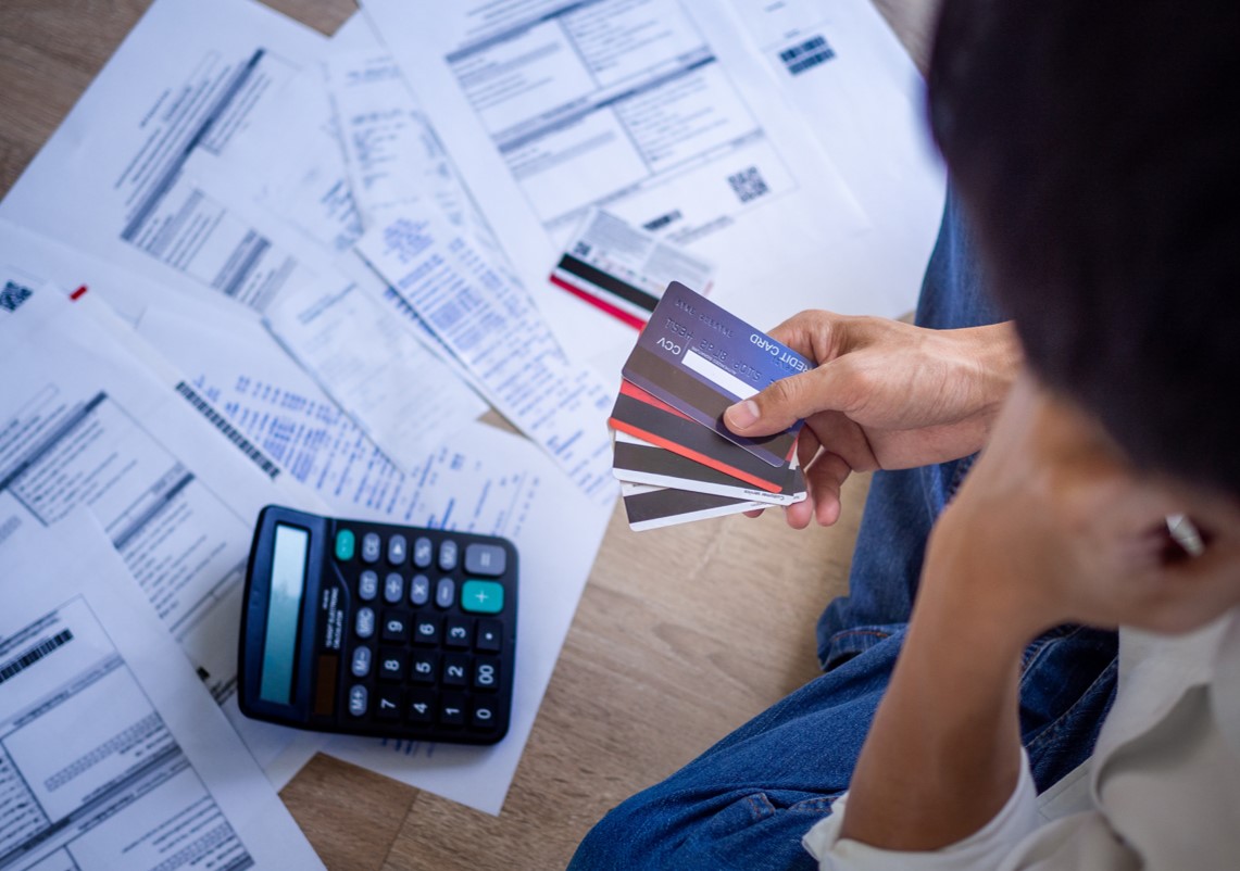 Man looking at bills and credit cards